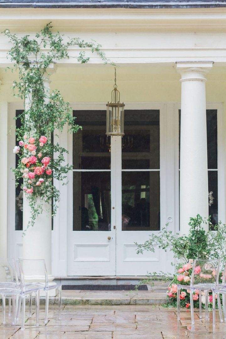outdoor wedding ceremony with garden style flowers on pillars 