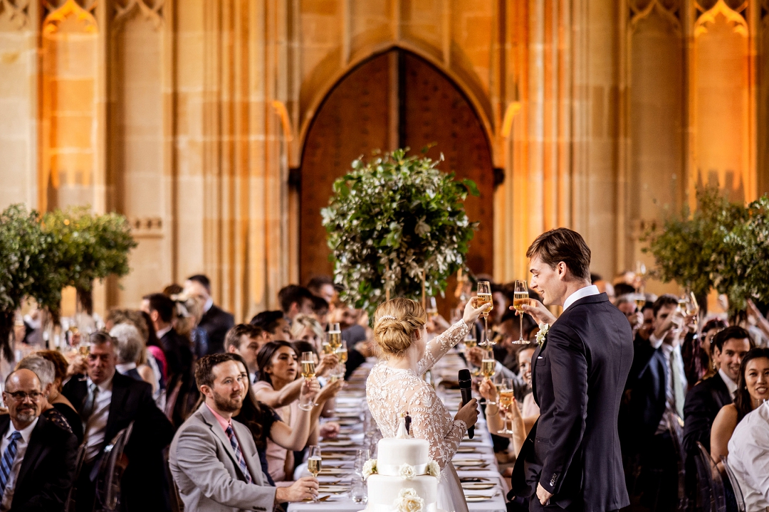 Bodleian Library wedding in Oxford happy couple toast to their guests
