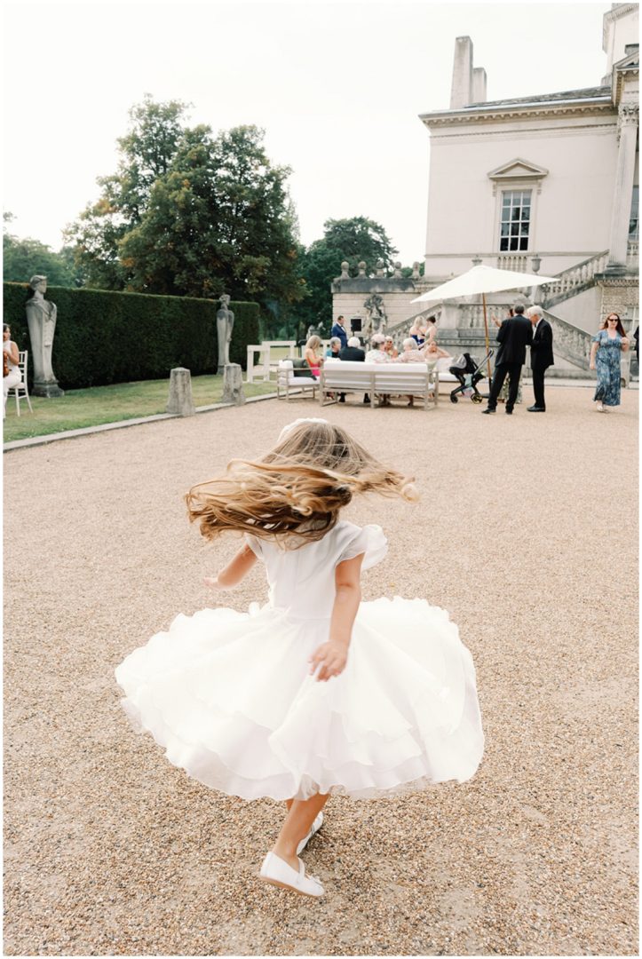 flower girl dancing at Chiswick House Wedding