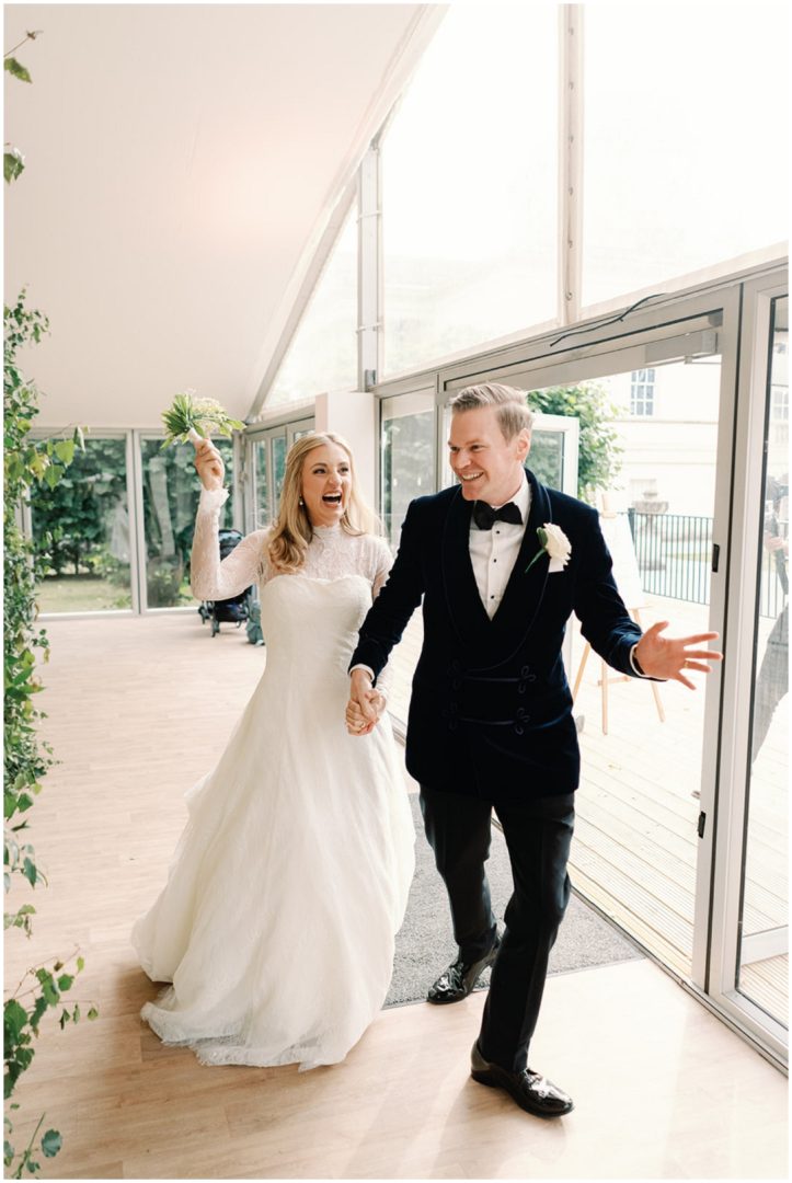 bride and groom enter wedding reception cheering at Chiswick House Wedding