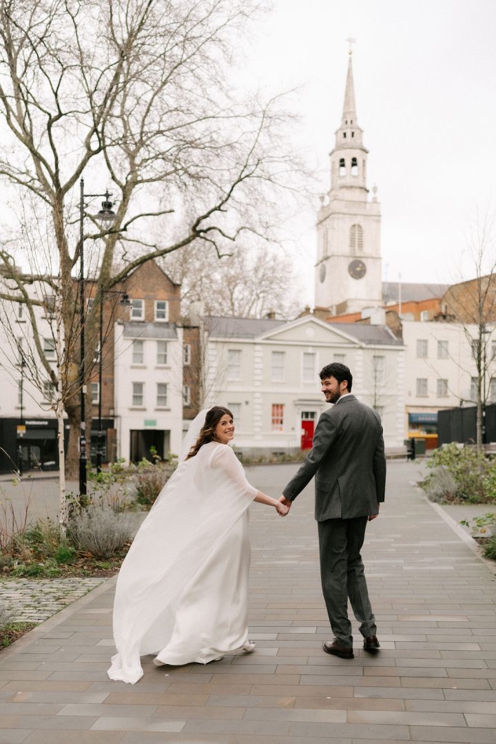 Bride and groom walking in Clerkenwell Square Old Sessions House wedding