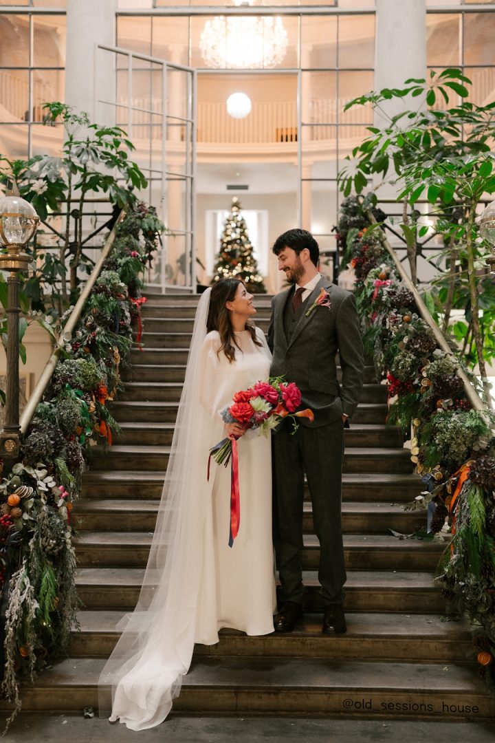 Bride and groom on stairs at Old Sessions House