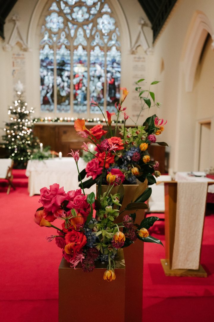 modern colourful Church flowers on gold plinths