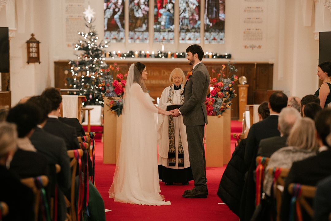 bride and groom holding hands, getting married at church