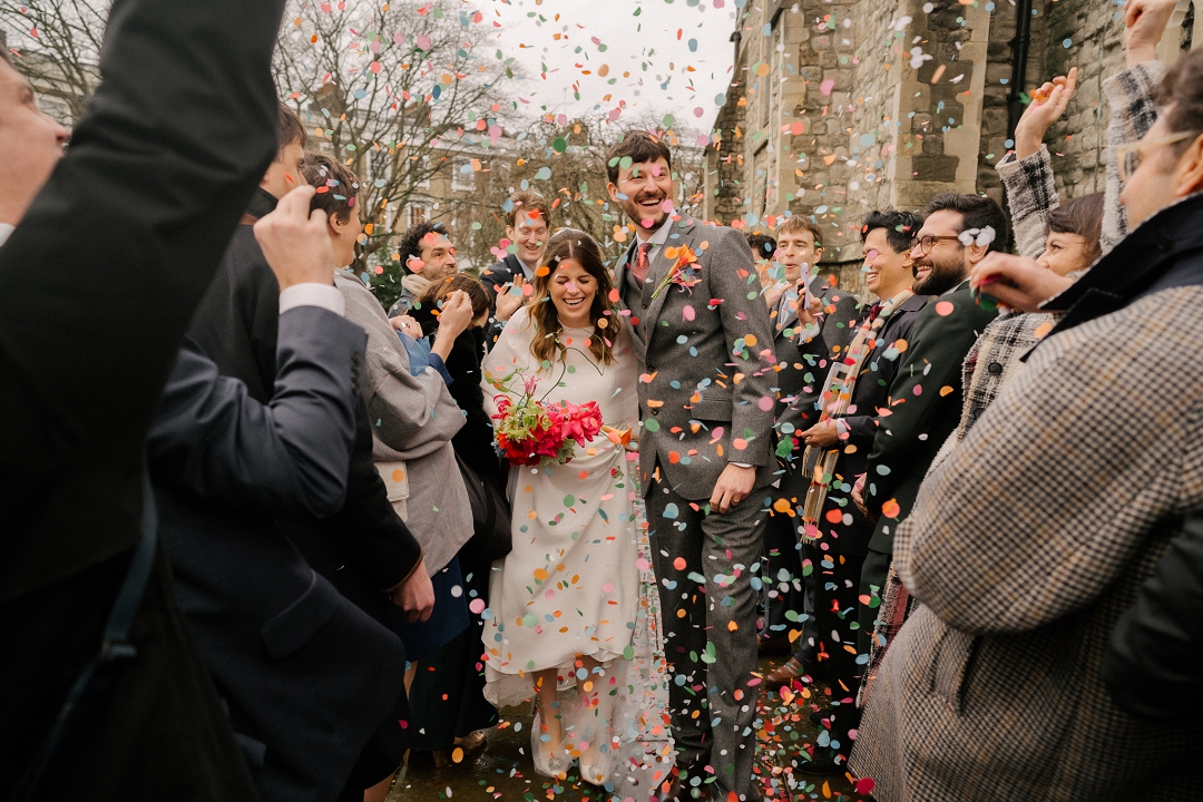 bride and groom walking through confetti shower