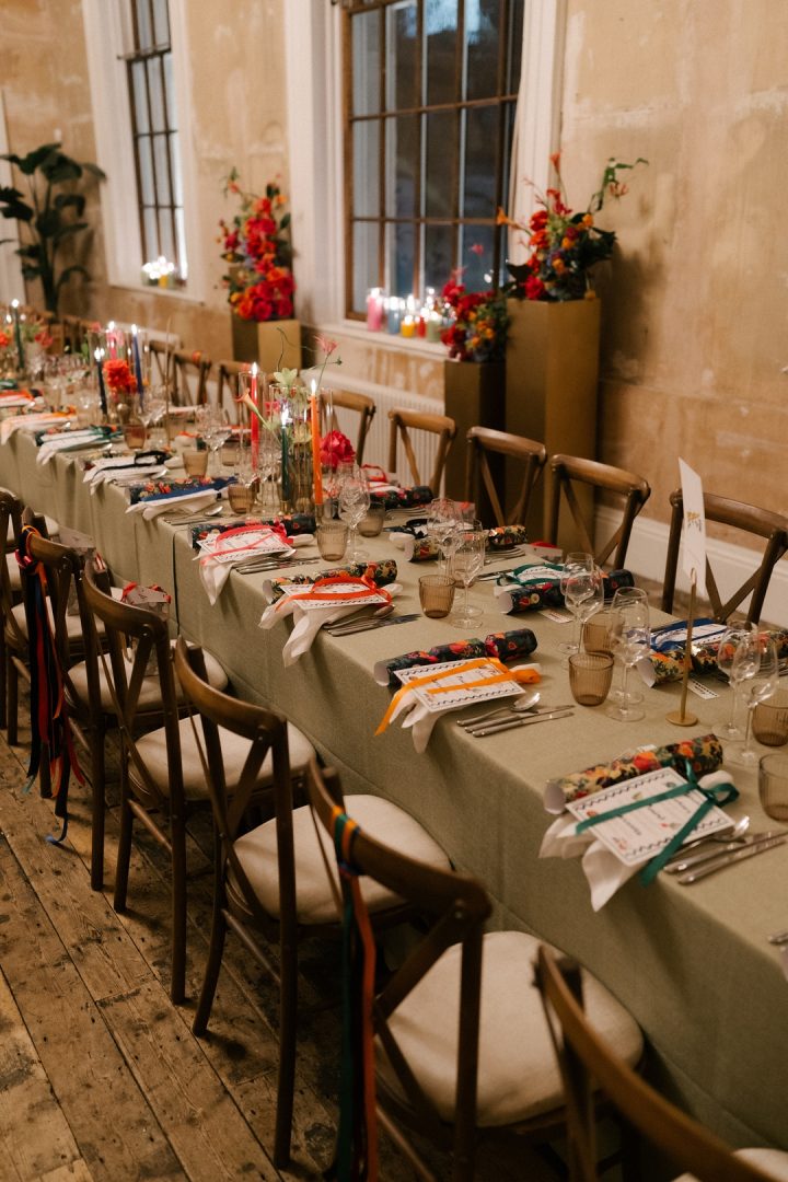 long dining tables with colourful flowers and candles at winter wedding at Old Sessions House London