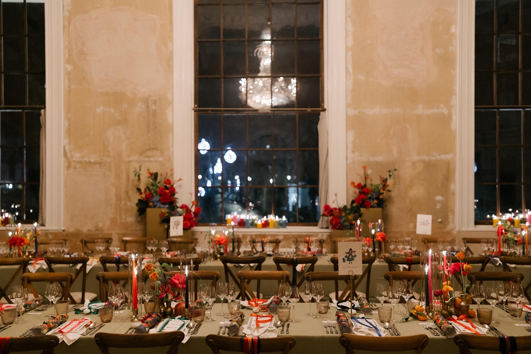 long dining tables with colourful flowers and candles at winter wedding at Old Sessions House London