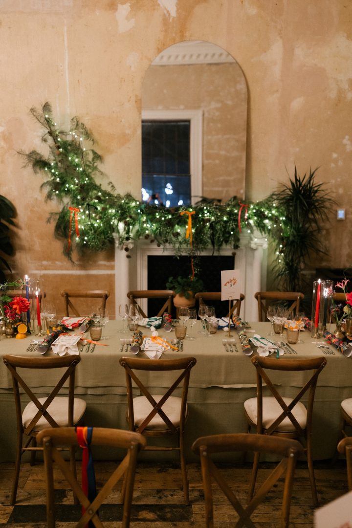 long dining tables with colourful flowers and candles at winter wedding at Old Sessions House London