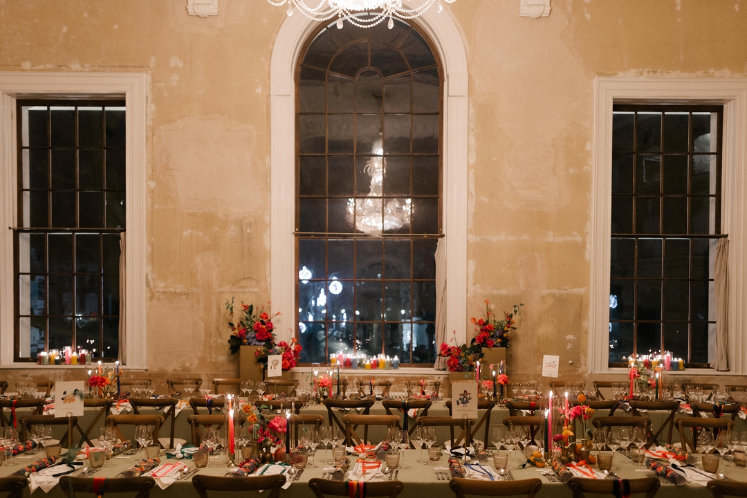 long dining tables with colourful flowers and candles at winter wedding at Old Sessions House London