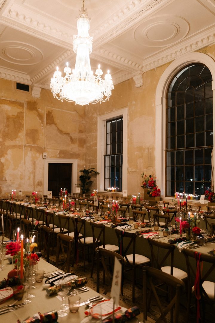 long dining tables with colourful flowers and candles at winter wedding at Old Sessions House London