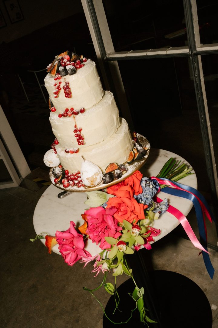 wedding cake with colourful bouquet at Old Sessions House wedding